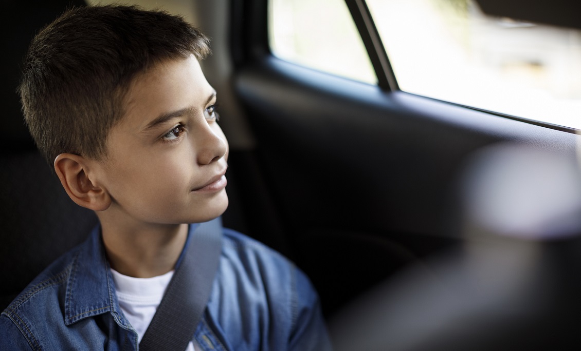 Smiling teenage boy in the car